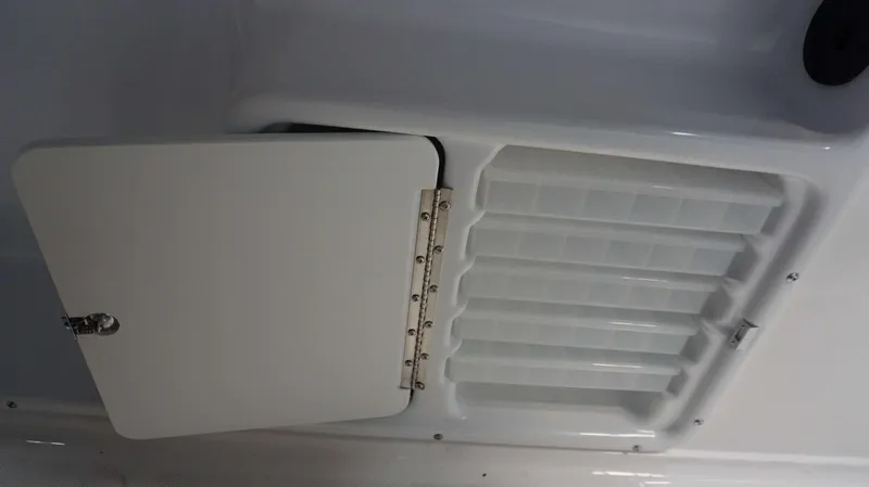 Slide: The Image of Hurricane 231 SS 2024 model boat storage compartment with open hatch and organized slots. - 15