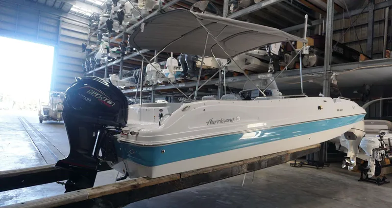 Slide: The Image of 2024 Hurricane 231 SS boat in storage with Yamaha outboard motor. - 17