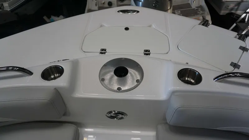 Slide: The Image of 2024 Hurricane 231 SS boat interior with cup holders and storage compartments. - 20