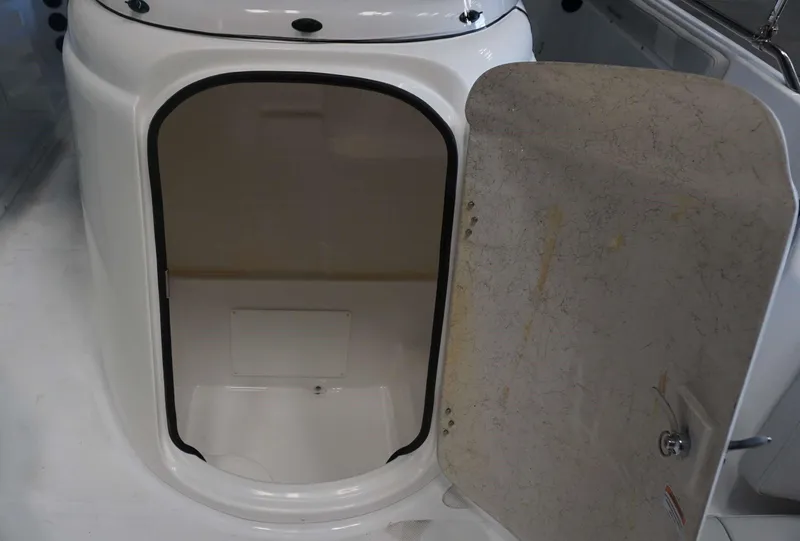 Slide: The Image of 2024 Hurricane 231 SS boat storage compartment with open door. - 22