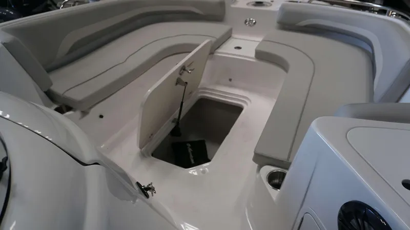Slide: The Image of 2024 Hurricane 231 SS boat interior with open storage compartment and cushioned seating. - 3