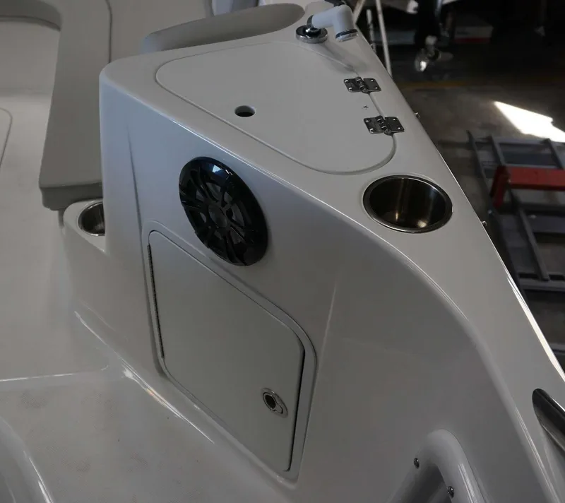 Slide: The Image of 2024 Hurricane 231 SS boat interior with speaker, cup holder, and storage compartment. - 4