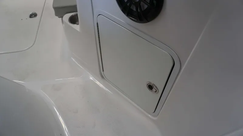 Slide: The Image of 2024 Hurricane 231 SS boat interior storage compartment and speaker detail. - 6