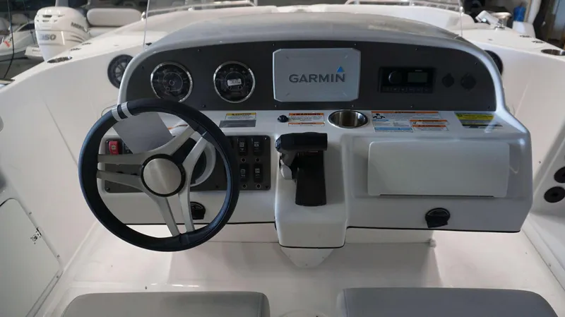 Slide: The Image of 2024 Hurricane 231 SS boat dashboard with Garmin navigation system and Mercury engine controls. - 7