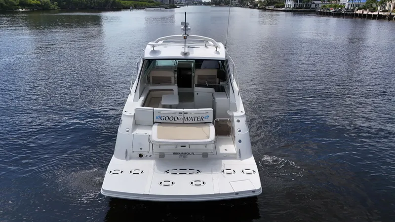 Slide: The Image of 2013 Sea Ray 450 Sundancer yacht cruising on a calm river. - 10