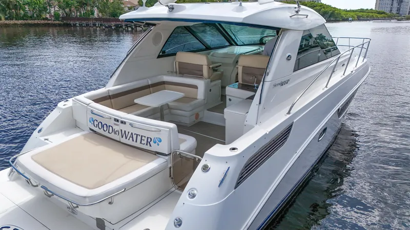 Slide: The Image of 2013 Sea Ray 450 Sundancer yacht on calm water, featuring spacious seating and sleek design. - 14