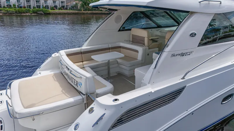 Slide: The Image of 2013 Sea Ray 450 Sundancer yacht with spacious seating and table on deck. - 2