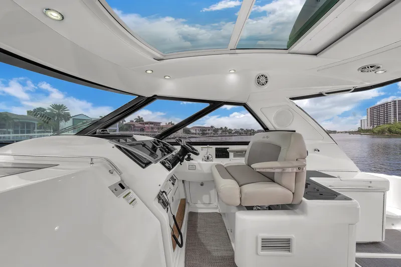 Slide: The Image of 2013 Sea Ray 450 Sundancer yacht interior with modern helm and panoramic windows. - 22