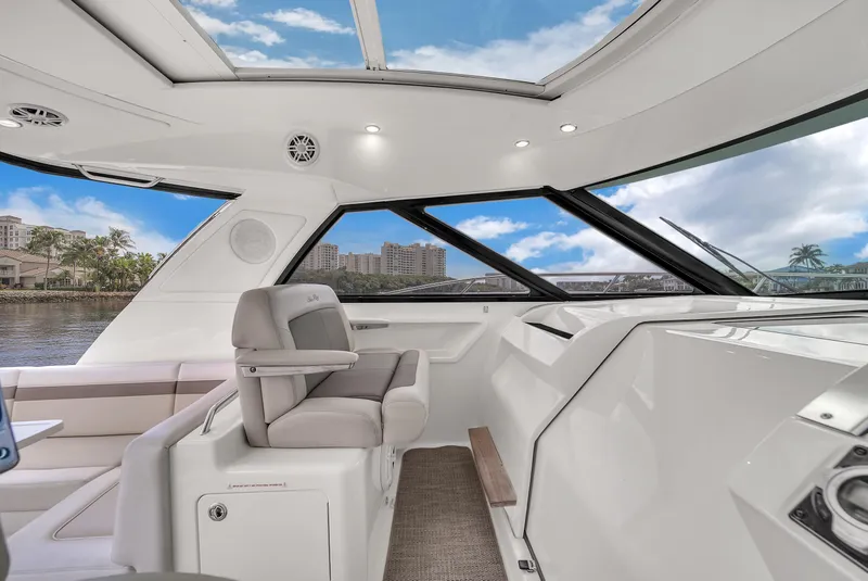 Slide: The Image of Interior of 2013 Sea Ray 450 Sundancer yacht with modern helm and seating. - 23