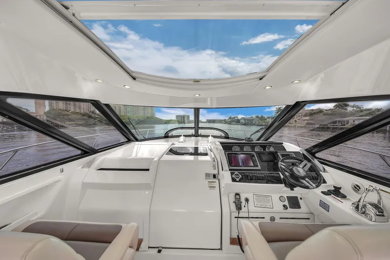 Slide: The Image of 2013 Sea Ray 450 Sundancer yacht cockpit with panoramic windows and modern controls. - 24