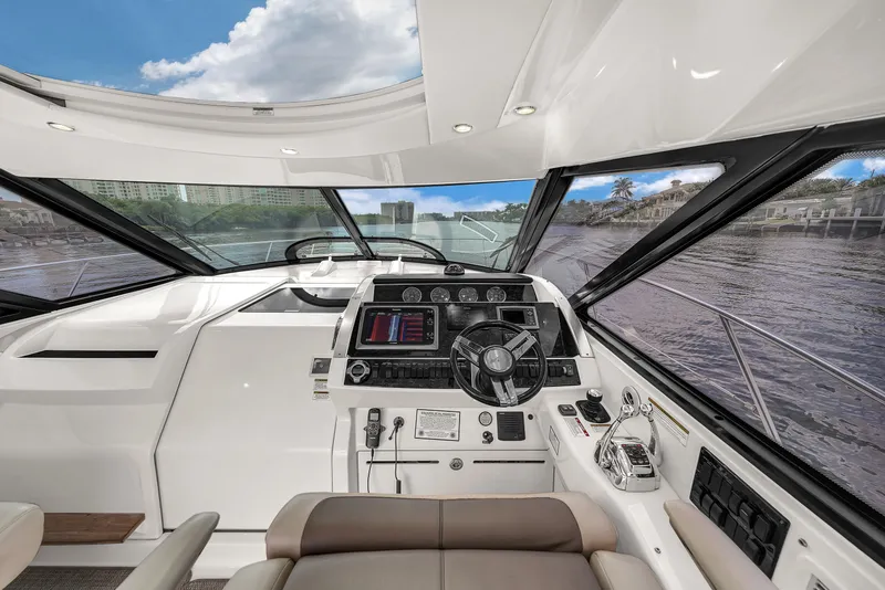 Slide: The Image of Interior view of 2013 Sea Ray 450 Sundancer yacht cockpit with modern controls and panoramic windows. - 25