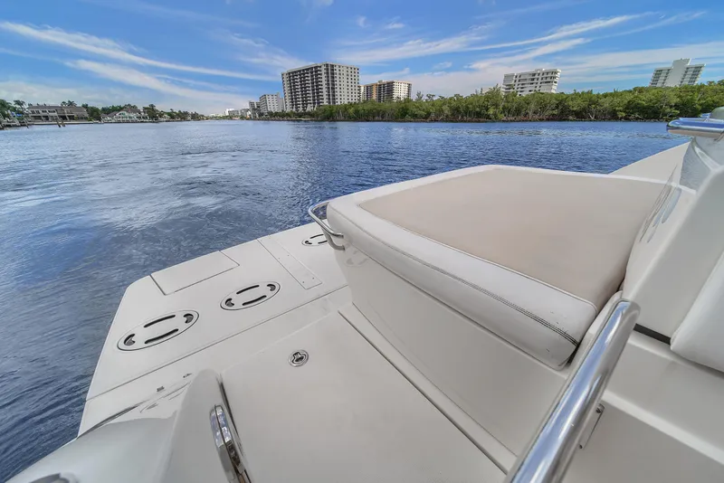 Slide: The Image of 2013 Sea Ray 450 Sundancer yacht on calm water with city skyline. - 26