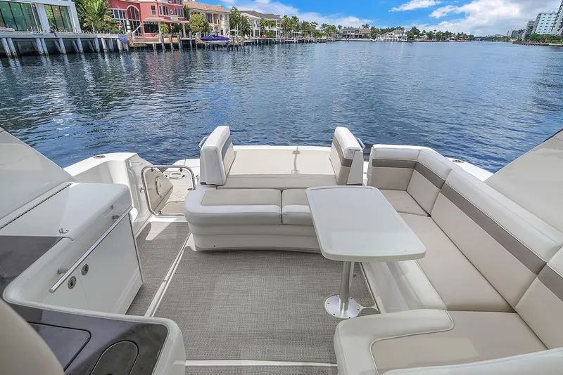 Slide: The Image of 2013 Sea Ray 450 Sundancer yacht with spacious deck seating and waterfront view. - 28