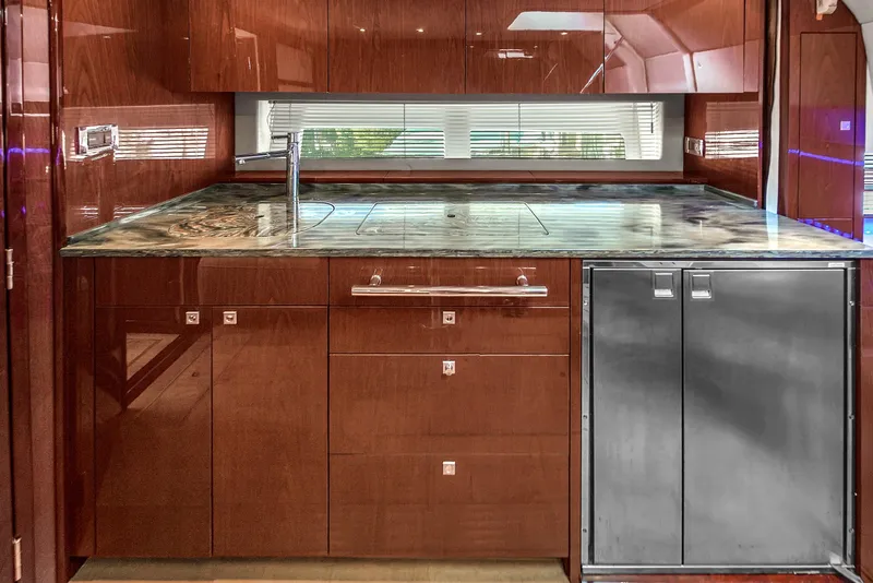 Slide: The Image of Luxurious kitchen interior of 2013 Sea Ray 450 Sundancer yacht with sleek cabinetry and modern appliances. - 35