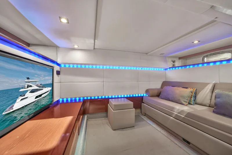 Slide: The Image of Luxurious interior of 2013 Sea Ray 450 Sundancer yacht with modern seating and ambient lighting. - 41