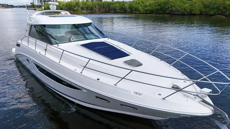Slide: The Image of 2013 Sea Ray 450 Sundancer yacht cruising on calm water. - 43