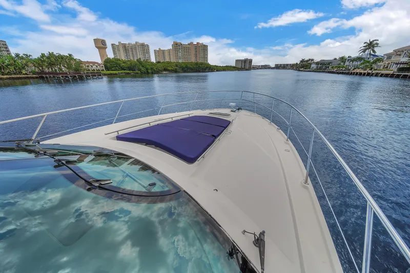 Slide: The Image of 2013 Sea Ray 450 Sundancer yacht cruising on a scenic waterway. - 46