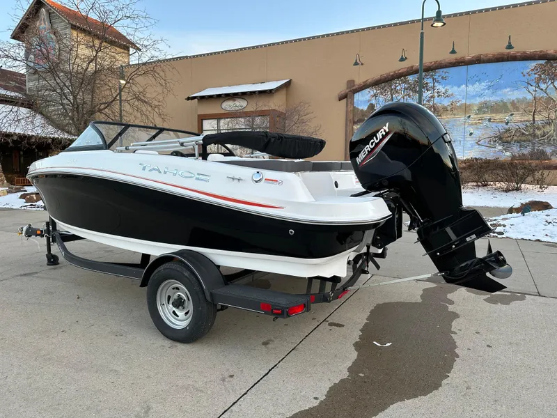 Slide: The Image of 2024 Tahoe 185 S boat with Mercury outboard motor on a trailer. - 2