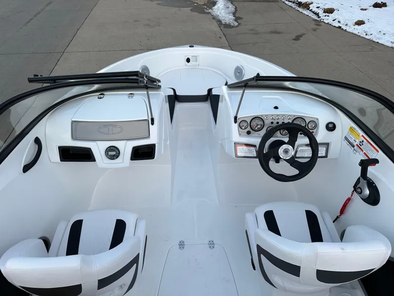 Slide: The Image of 2024 Tahoe 185 S boat interior with steering wheel and seating. - 4