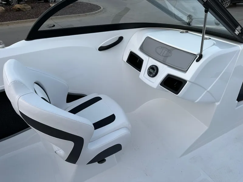 Slide: The Image of 2024 Tahoe 185 S boat interior with white and black captain's chair and dashboard. - 5