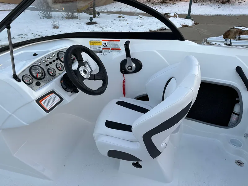 Slide: The Image of 2024 Tahoe 185 S boat cockpit with steering wheel and captain's chair. - 6