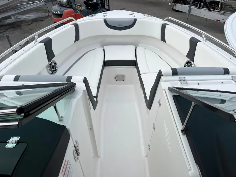 Slide: The Image of 2023 Chaparral 250 OSX boat interior with white and black seating. - 13