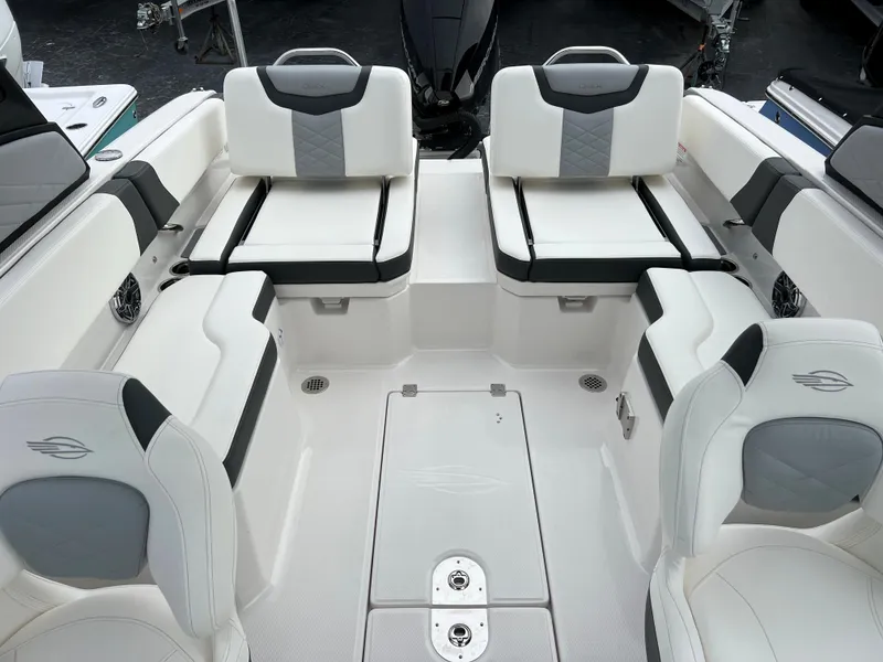 Slide: The Image of 2023 Chaparral 250 OSX boat interior with white and gray seating. - 17