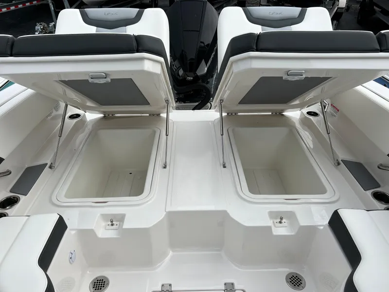 Slide: The Image of 2023 Chaparral 250 OSX boat with open storage compartments. - 18