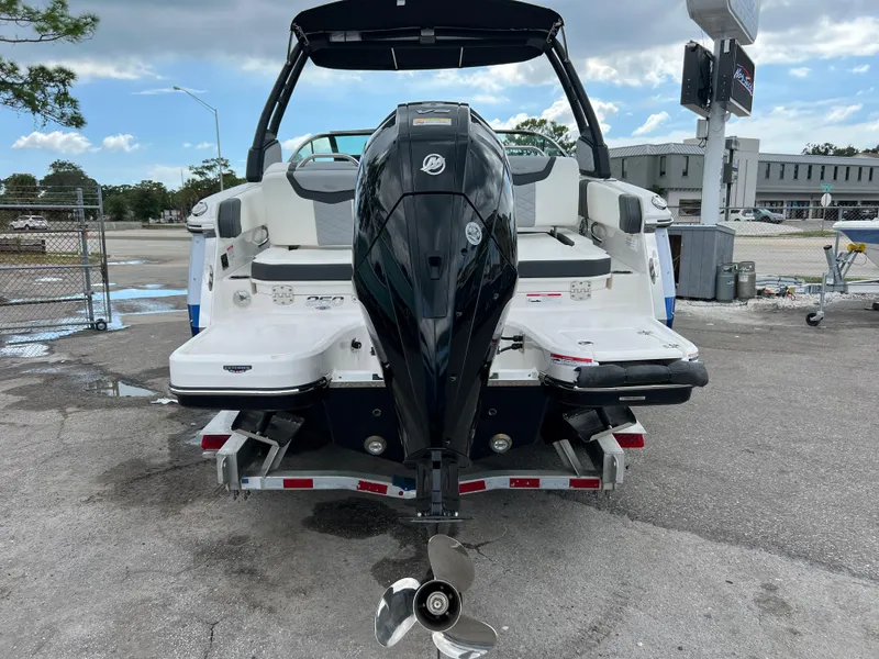 Slide: The Image of 2023 Chaparral 250 OSX boat rear view with outboard motor on trailer. - 4
