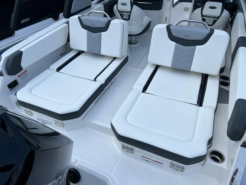 Slide: The Image of 2023 Chaparral 250 OSX boat interior with adjustable white and gray seating. - 8