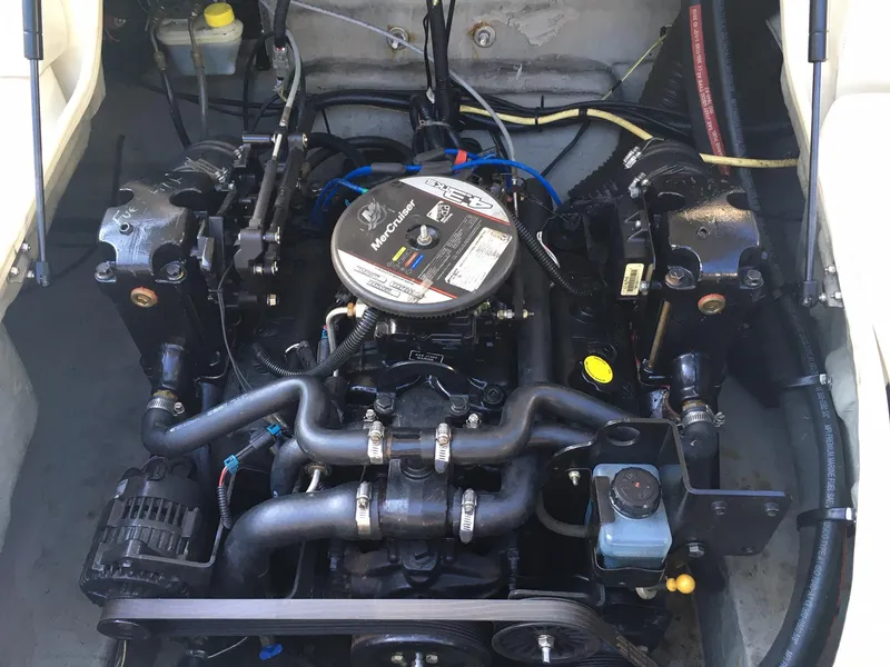 Slide: The Image of 2011 Bayliner Discovery 192 engine compartment with MerCruiser engine. - 2