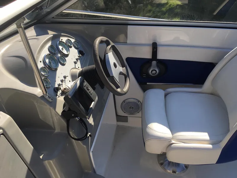 Slide: The Image of 2011 Bayliner Discovery 192 boat cockpit with steering wheel and control panel. - 4