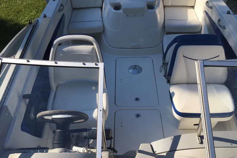 Slide: The Image of 2011 Bayliner Discovery 192 boat interior with seating and steering wheel. - 5