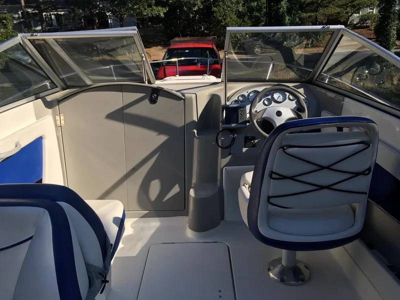 Slide: The Image of 2011 Bayliner Discovery 192 boat interior with steering wheel and seating. - 6