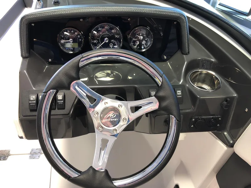 Slide: The Image of 2024 Monterey M-205 boat dashboard with steering wheel and instrument panel. - 11