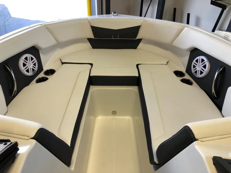 Slide: The Image of 2024 Monterey M-205 boat interior with white and black seating, cup holders, and speakers. - 12