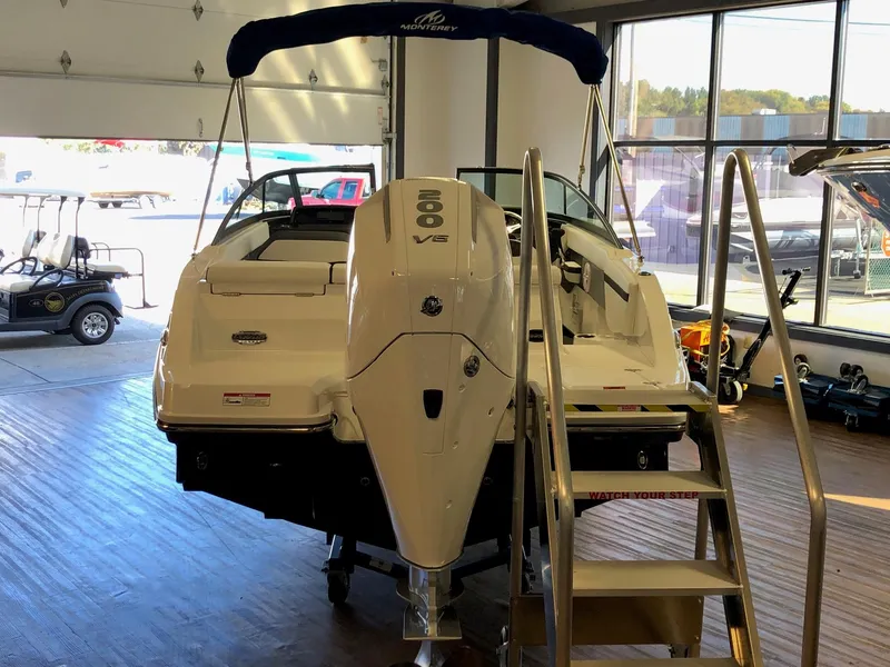 Slide: The Image of 2024 Monterey M-205 boat in showroom, rear view with outboard motor. - 6
