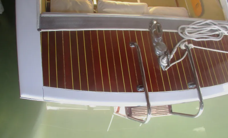 Slide: The Image of 1963 Coronado 21 by Century boat deck with wooden finish and metal railings. - 12