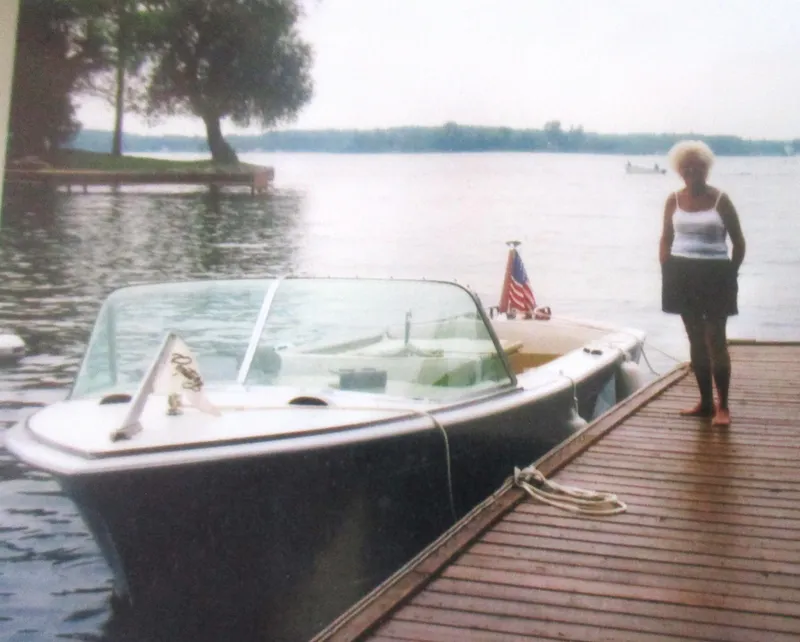 Slide: The Image of 1963 Coronado 21 by Century boat docked with a person standing nearby. - 3