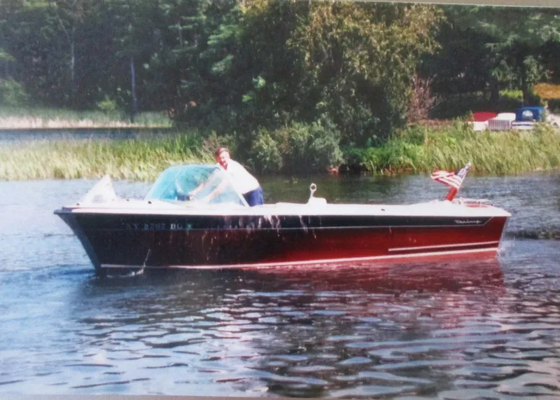 Slide: The Image of 1963 Coronado 21 by Century boat on a lake with a person steering. - 5