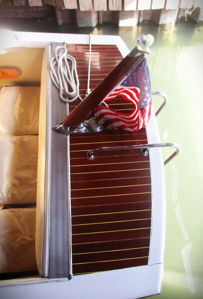 Slide: The Image of 1963 Coronado 21 by Century boat with American flag and wooden deck. - 8