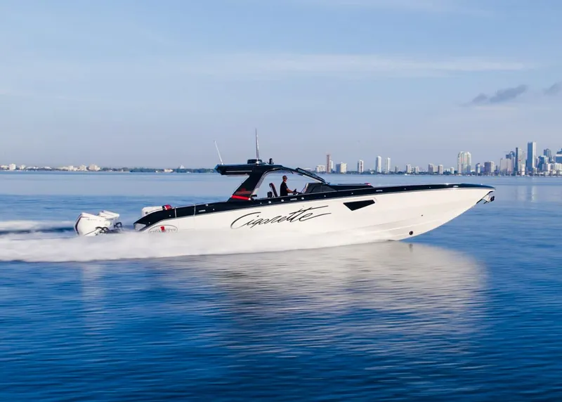 Slide: The Image of 2025 Cigarette 52 Thunder speedboat cruising on calm waters near a city skyline. - 16