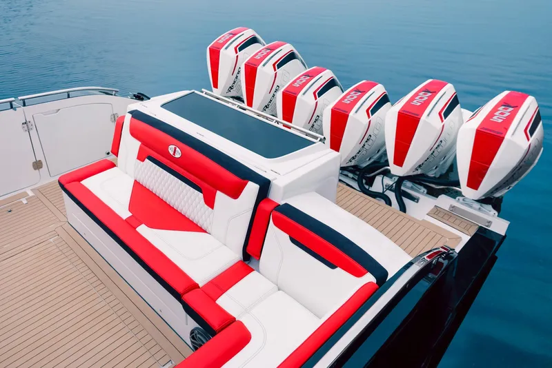Slide: The Image of 2025 Cigarette 52 Thunder boat with red and white seating and multiple outboard engines. - 19
