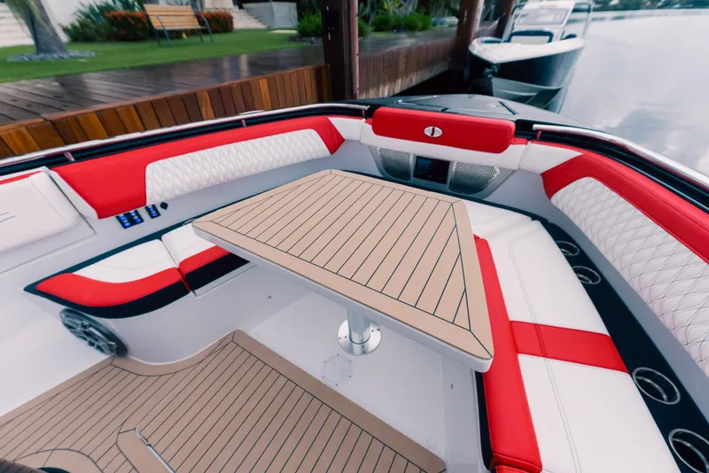 Slide: The Image of Luxury seating area on 2025 Cigarette 52 Thunder boat with red and white upholstery. - 25