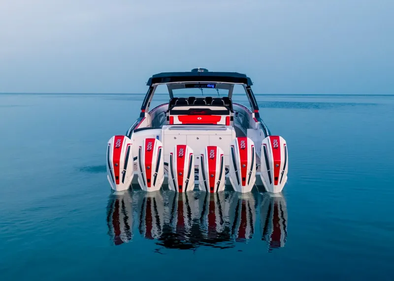 Slide: The Image of 2025 Cigarette 52 Thunder boat with multiple outboard engines on calm water. - 5