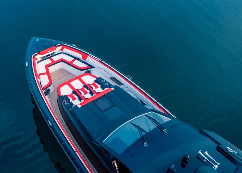 Slide: The Image of 2025 Cigarette 52 Thunder luxury speedboat with red and white seating on calm water. - 6