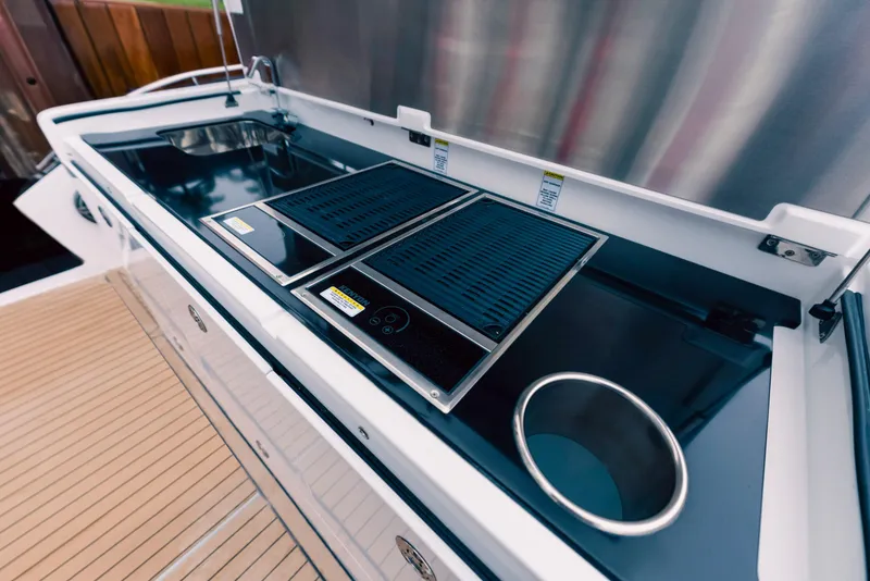 Slide: The Image of Outdoor kitchen on the 2025 Cigarette 52 Thunder boat with grill and sink. - 9