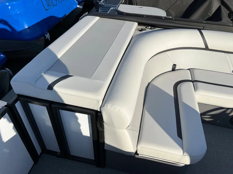 Slide: The Image of 2024 Crest Classic LX 220 boat interior with white cushioned seating. - 12