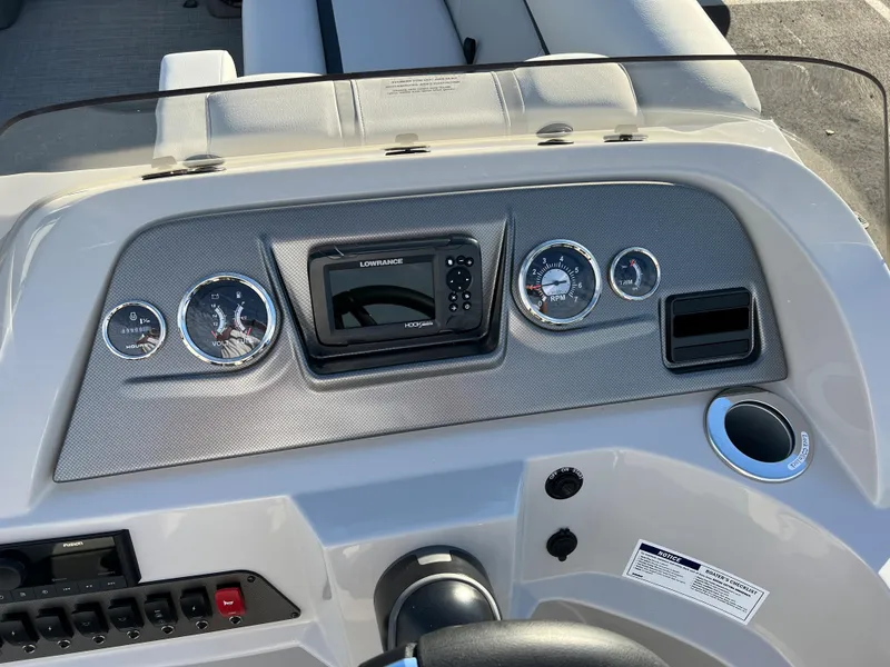 Slide: The Image of 2024 Crest Classic LX 220 boat dashboard with gauges and Lowrance display. - 17