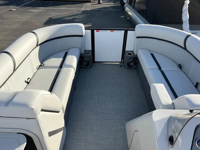 Slide: The Image of 2024 Crest Classic LX 220 pontoon boat interior with spacious seating. - 20